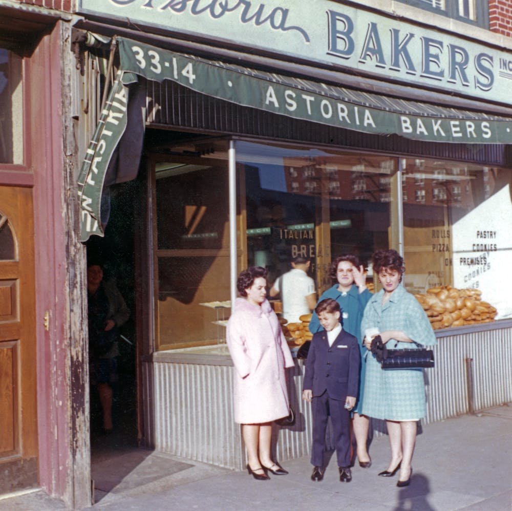 a group of people walking in front of a store