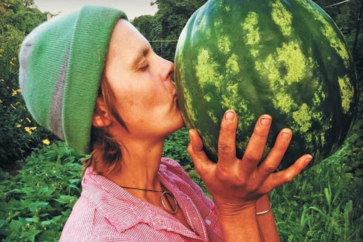 a farmer kissing a watermelon