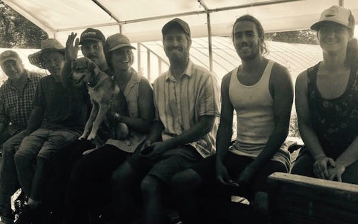 a black and white photo of a group of farmers smiling