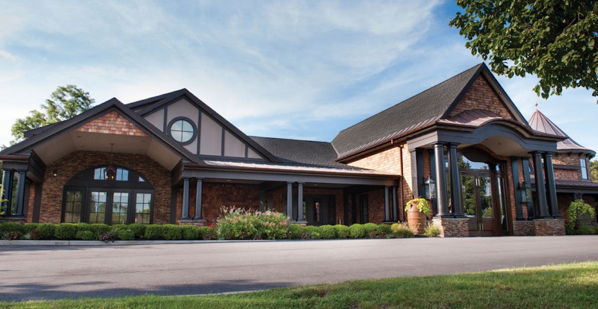 a small clock tower in front of a house