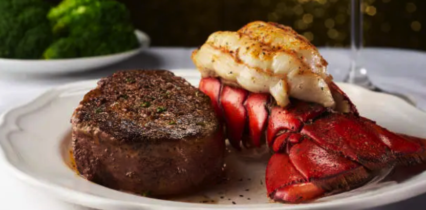 a plate of food with a slice of cake on a table