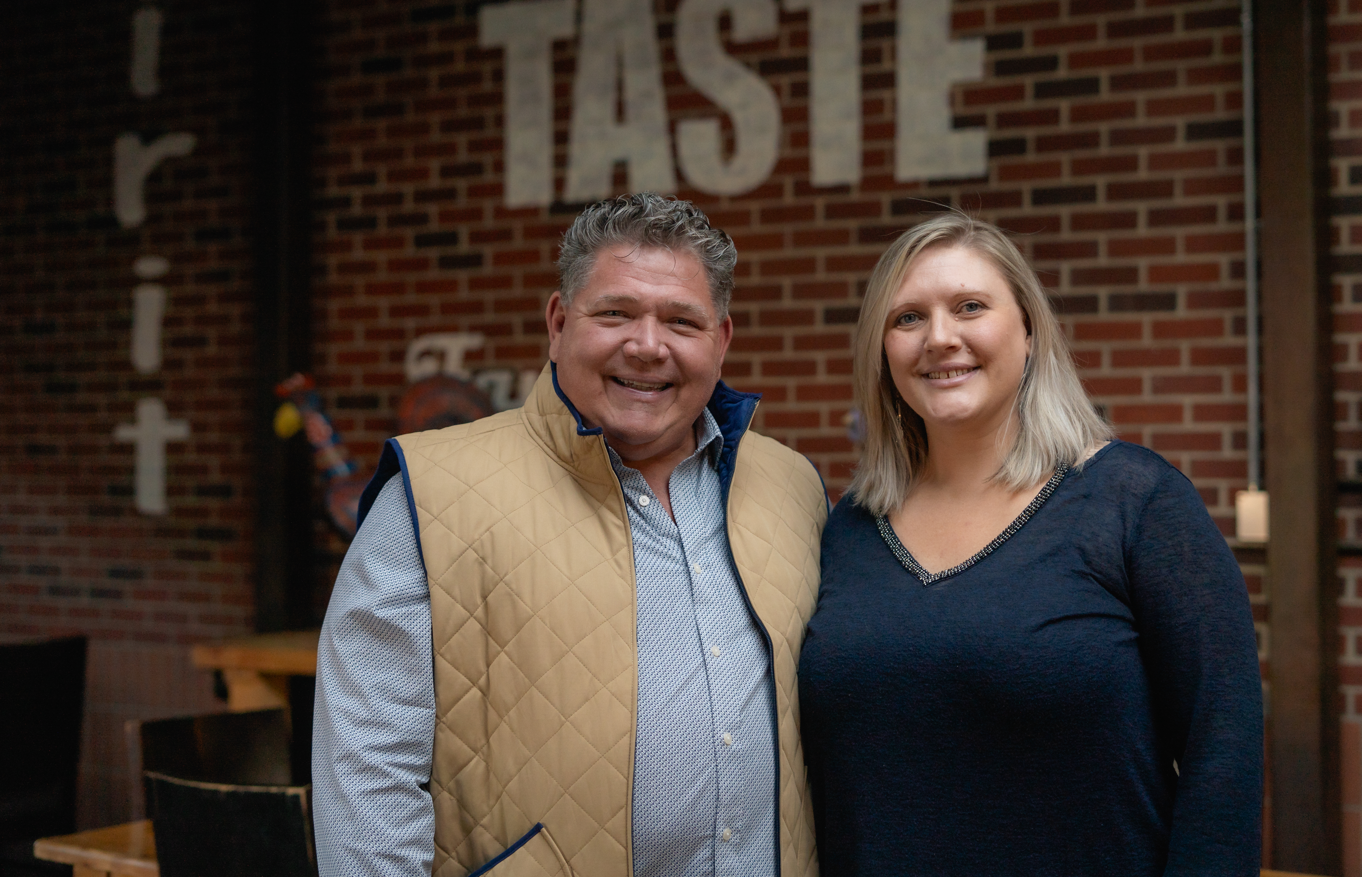 a man and a woman standing in front of a building