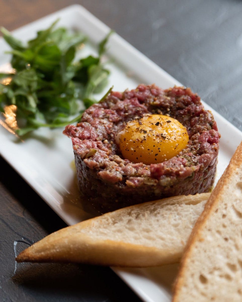 a close up of a plate of food with a slice cut out