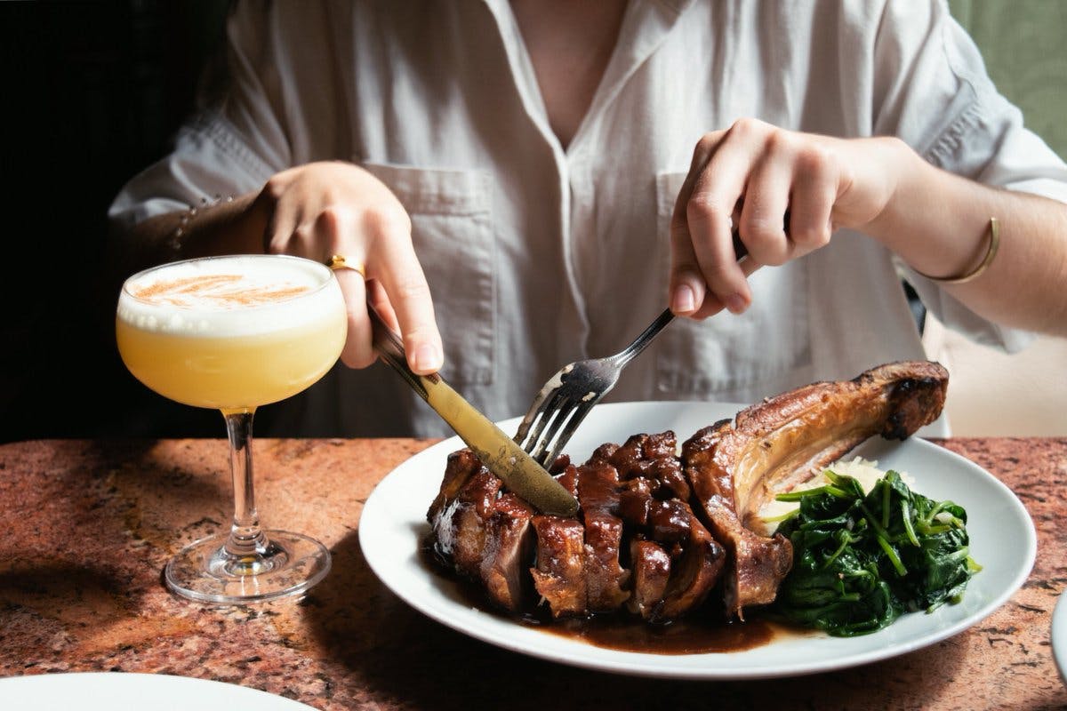 a person sitting at a table with a plate of food