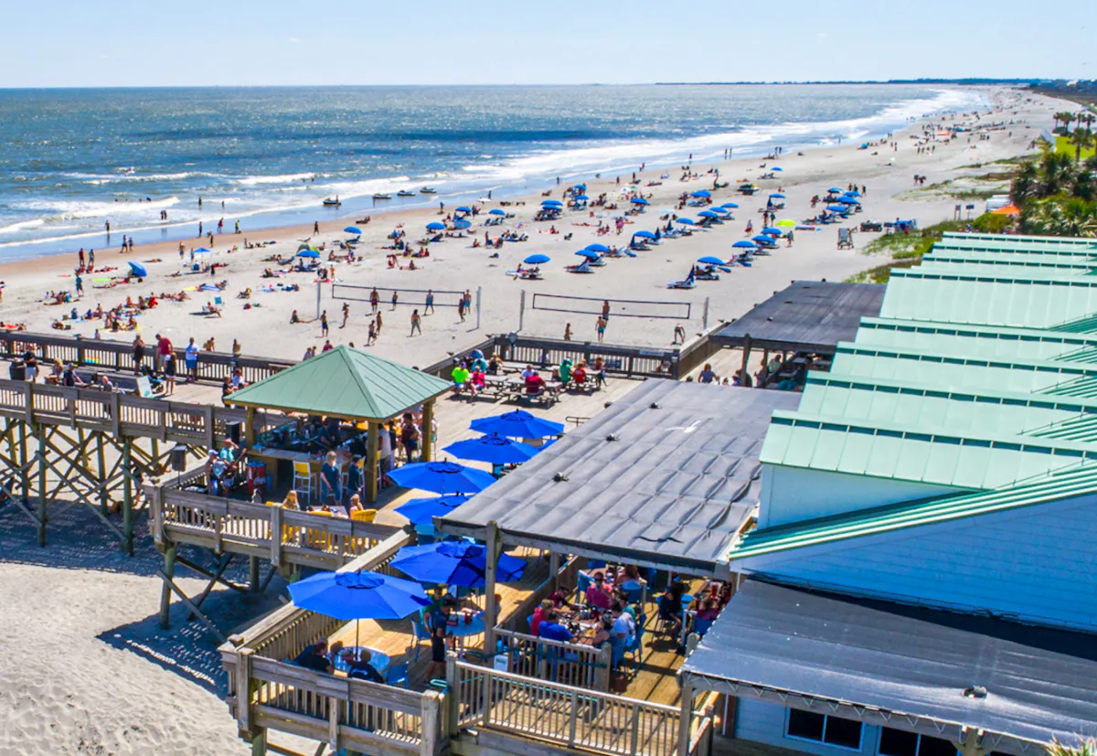 a group of people sitting at a beach