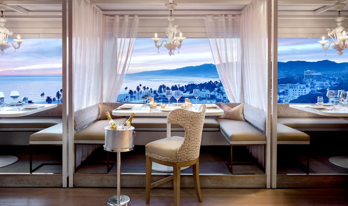 malibu cabana with an ocean view in the background and a champagne bucket