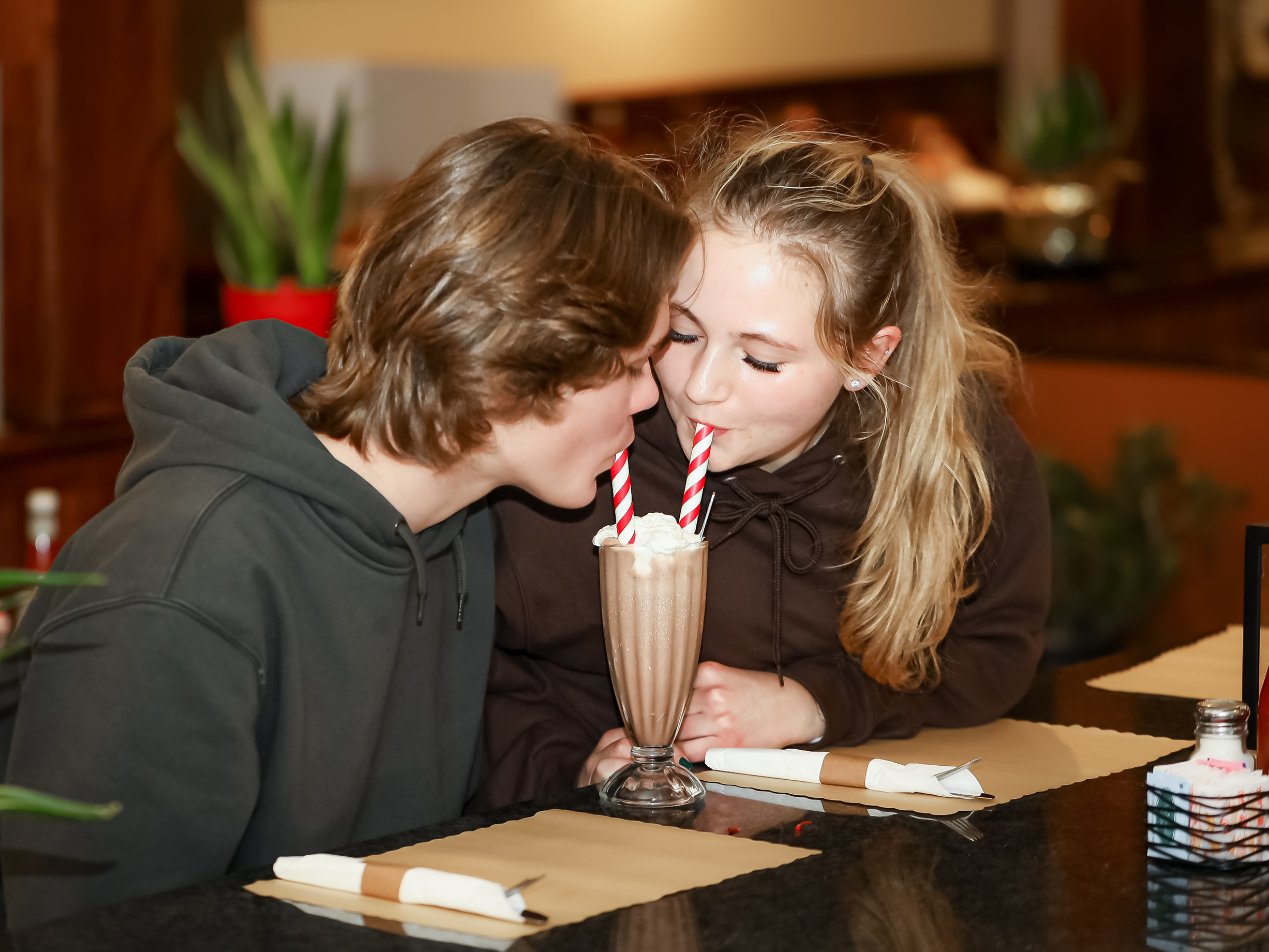 a little girl sitting at a table