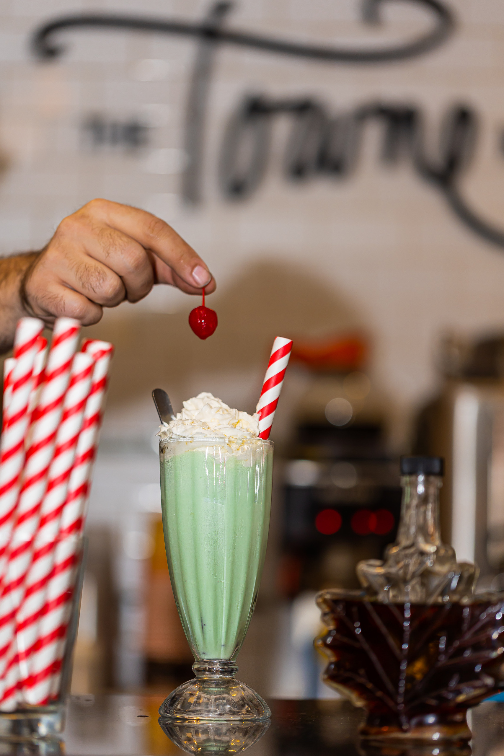 a hand holding a glass of wine