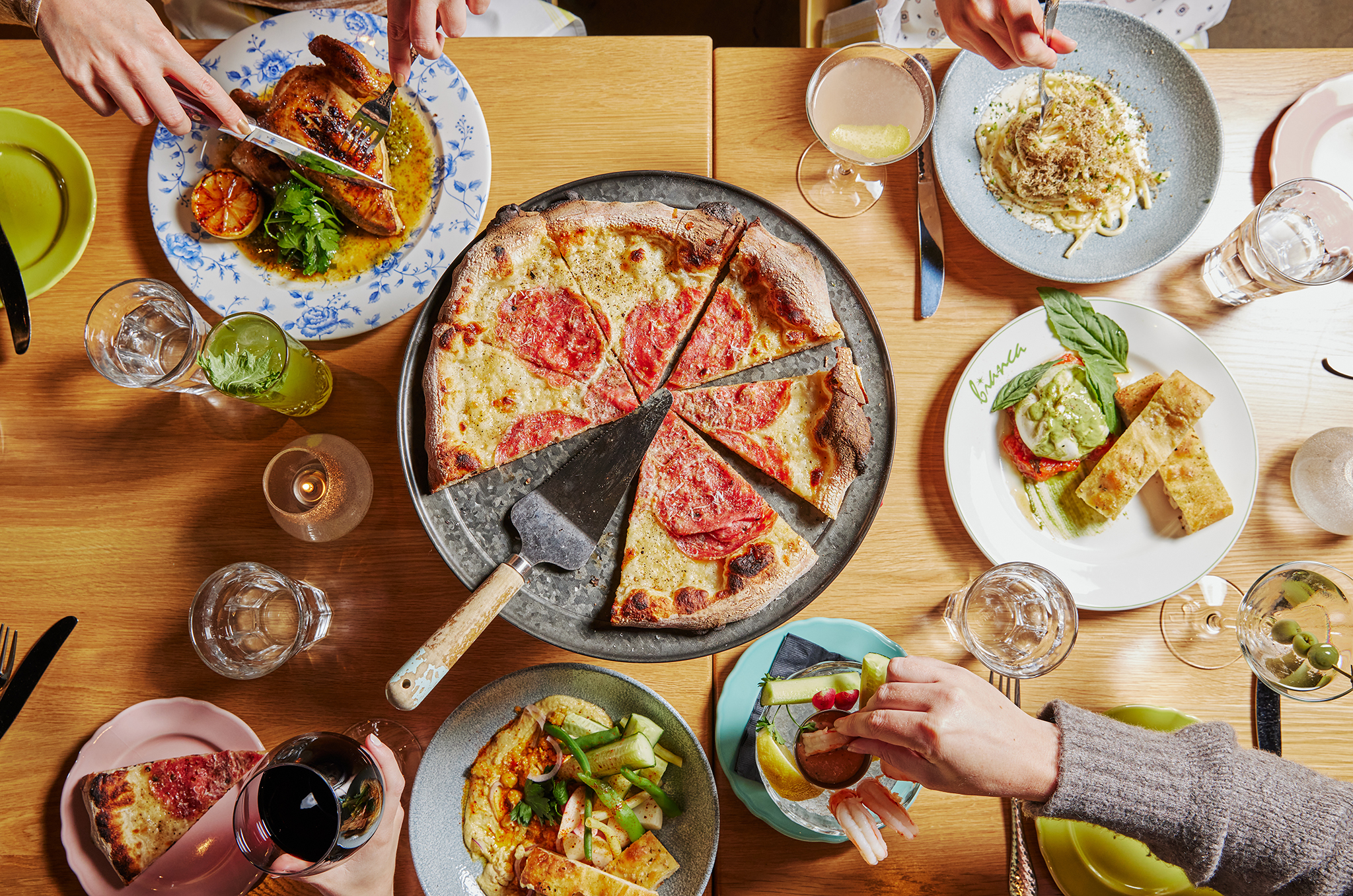 a group of people sitting at a table with a plate of food