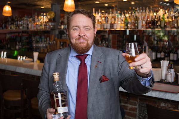 a man holding a bottle of wine