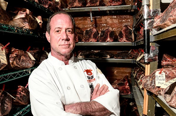 John Piccolino in a meat fridge posing for the camera