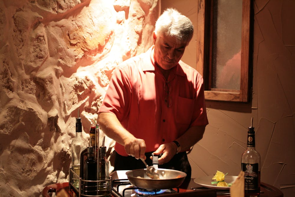 a man cooking food on a table