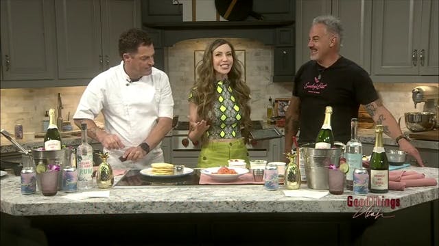 a couple of people that are standing in a kitchen preparing food on tv