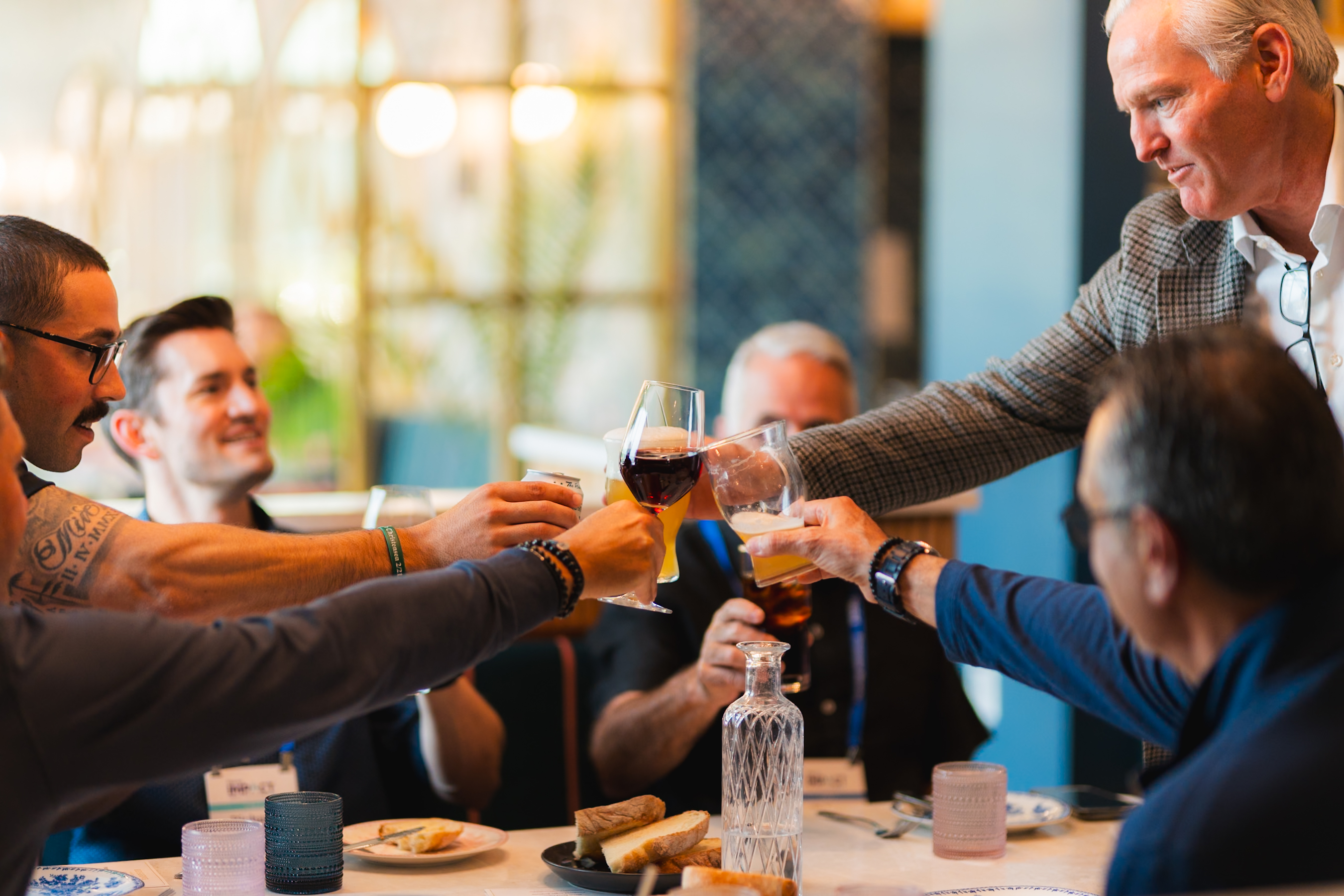 table of people cheersing drinks