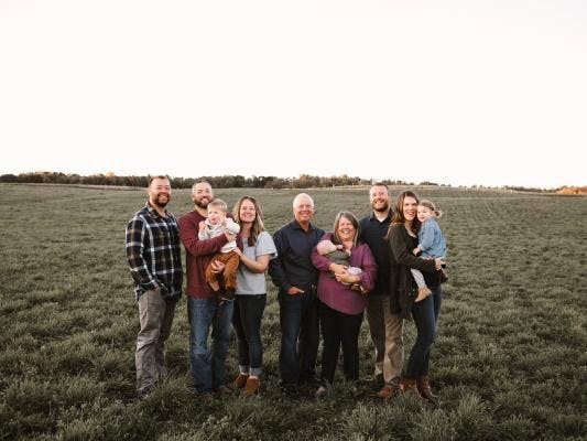 a group of people standing in the grass