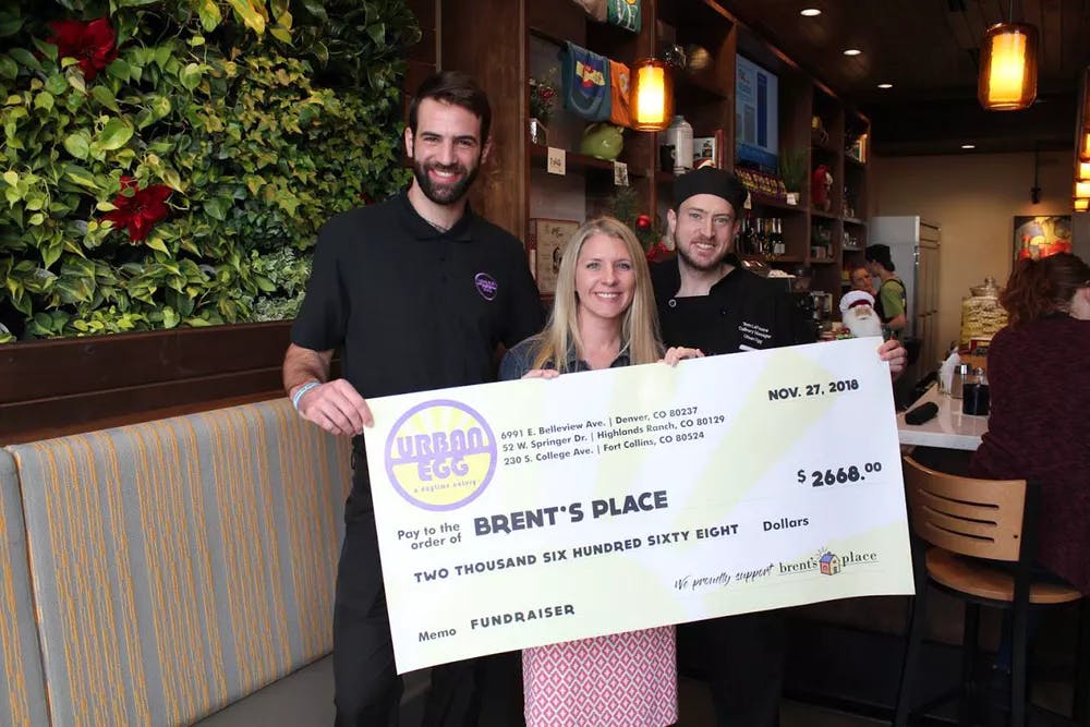 Group Posing with Jumbo Donation Check for Brent's Place