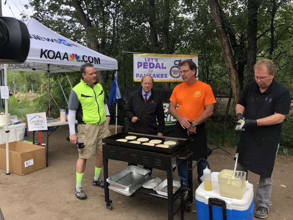 Group standing around pancake griddle for Bike to Work Day