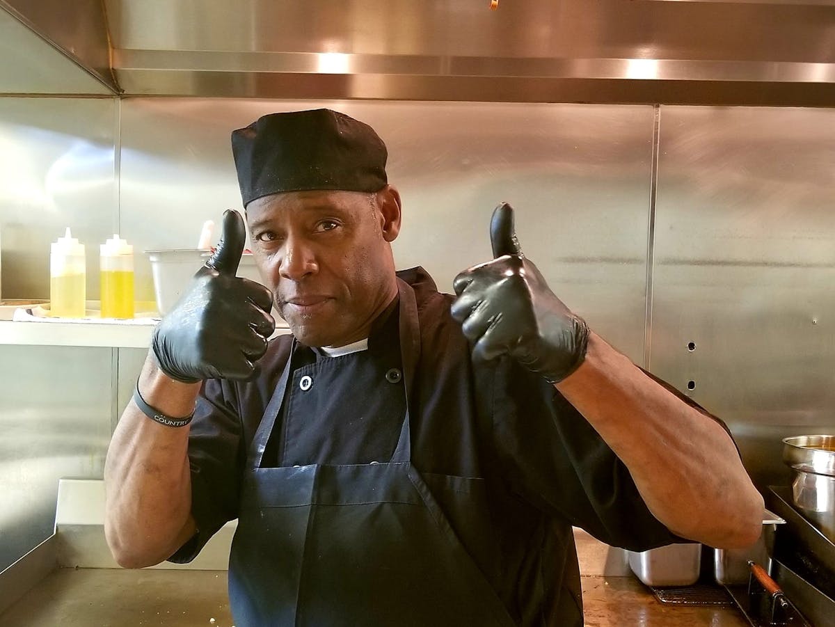 Kitchen Staff Member Giving a Thumbs Up