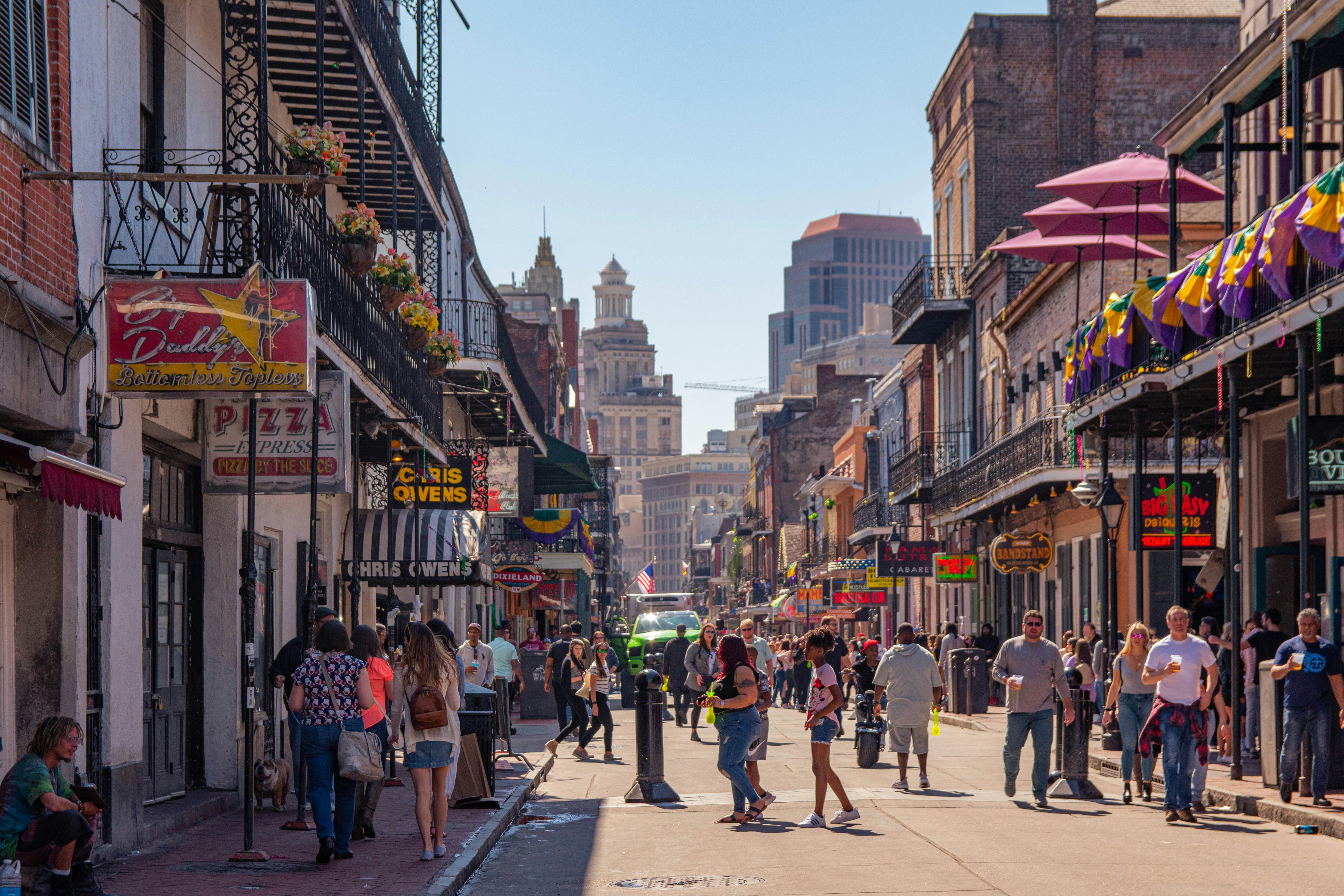 a group of people walking on a city street