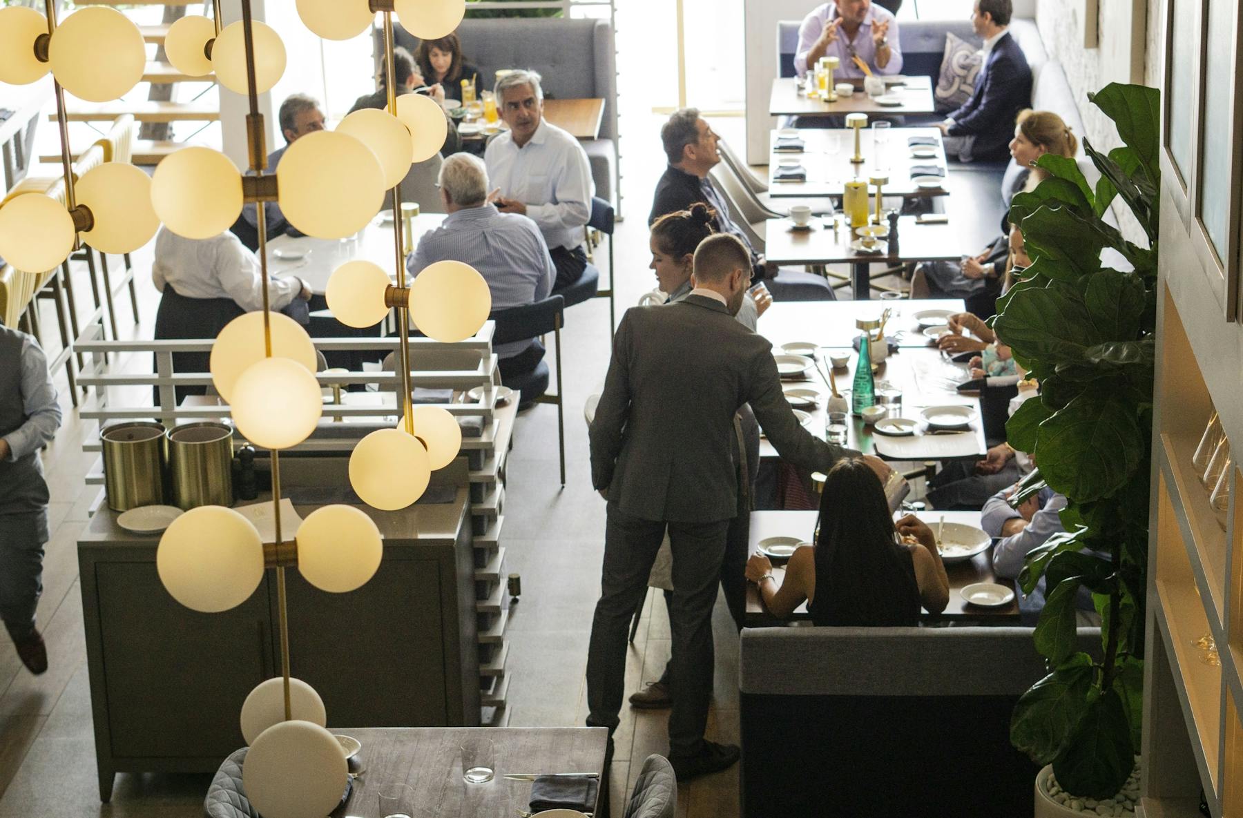 a group of people standing around a table