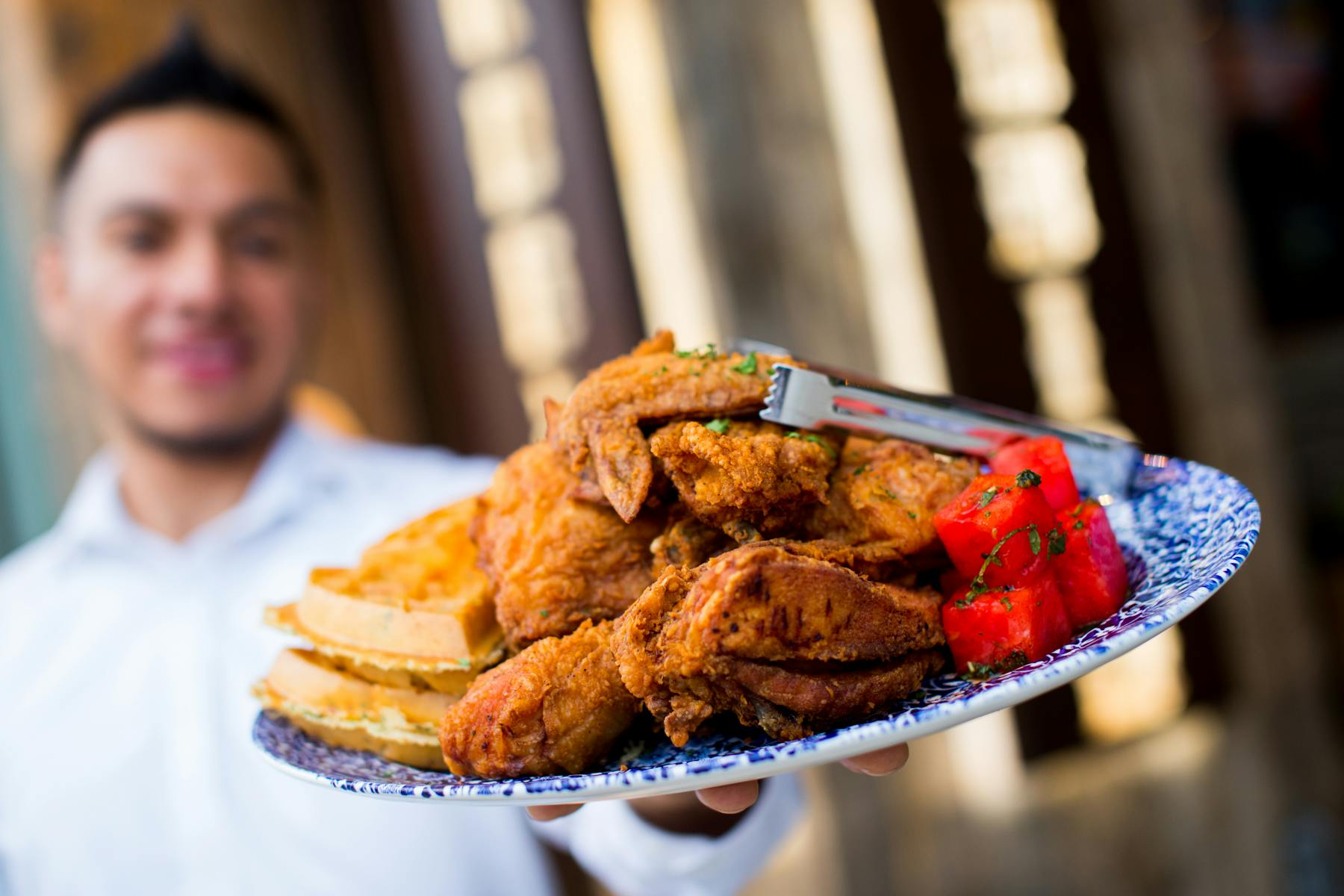 a person standing in front of a plate of food