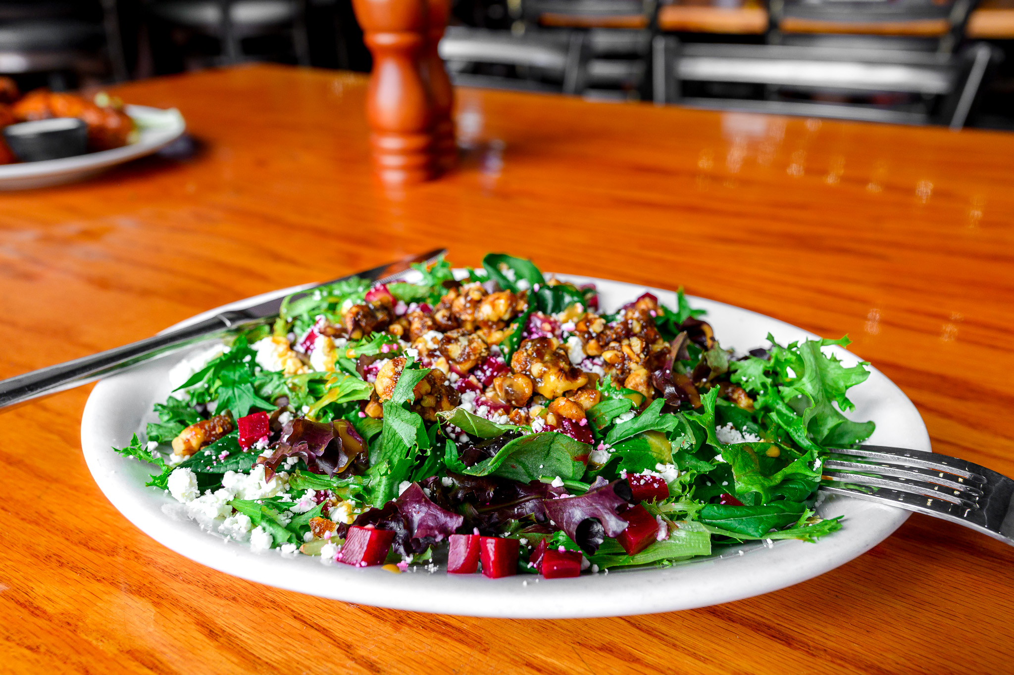 a plate of food sitting on top of a wooden table