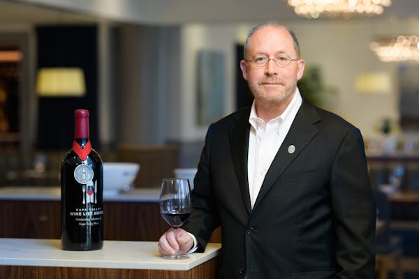 a man holding a glass of wine