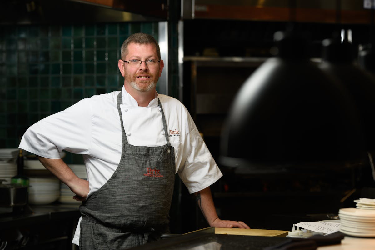 a man standing in front of a table