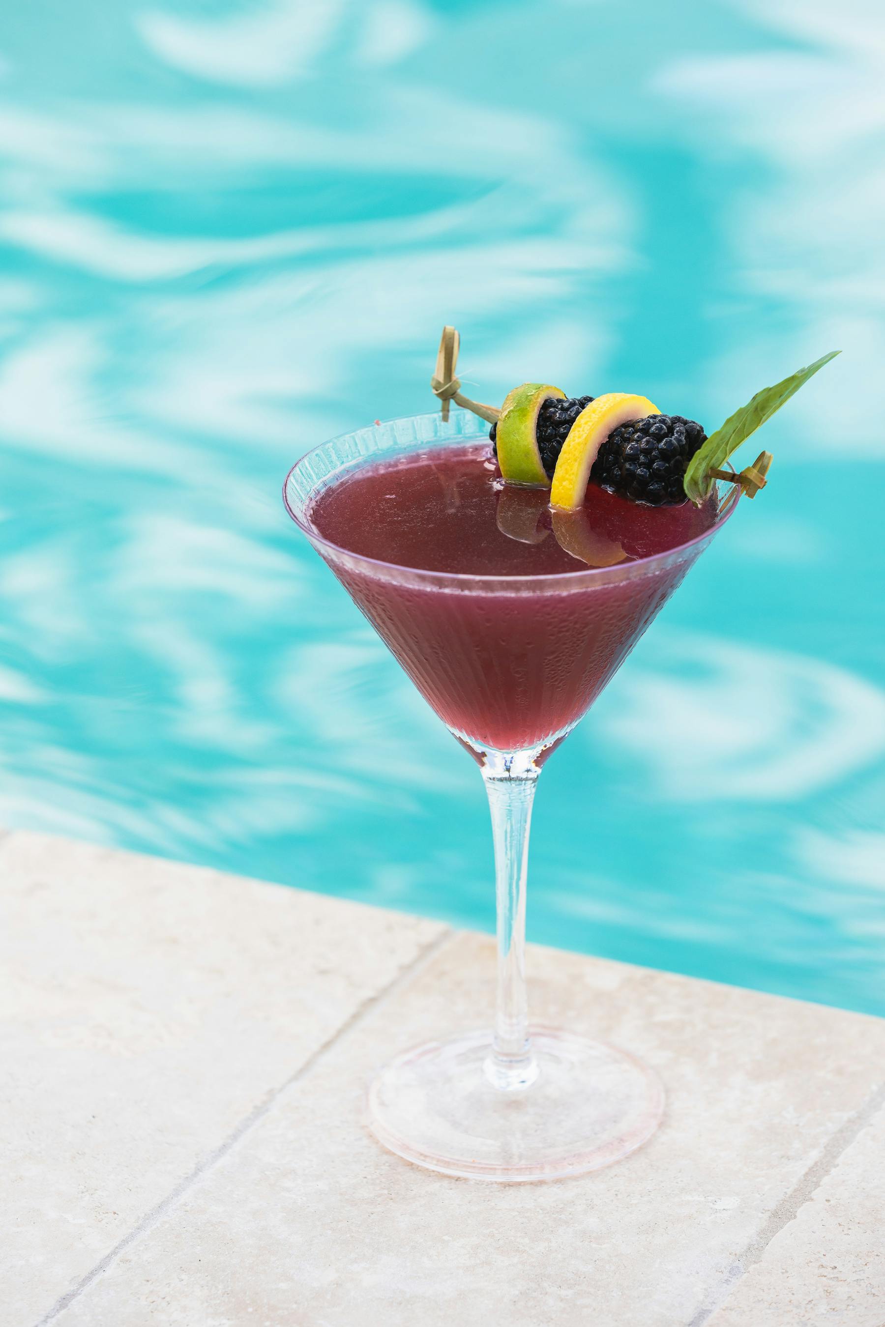 Purple cocktail  by pool
