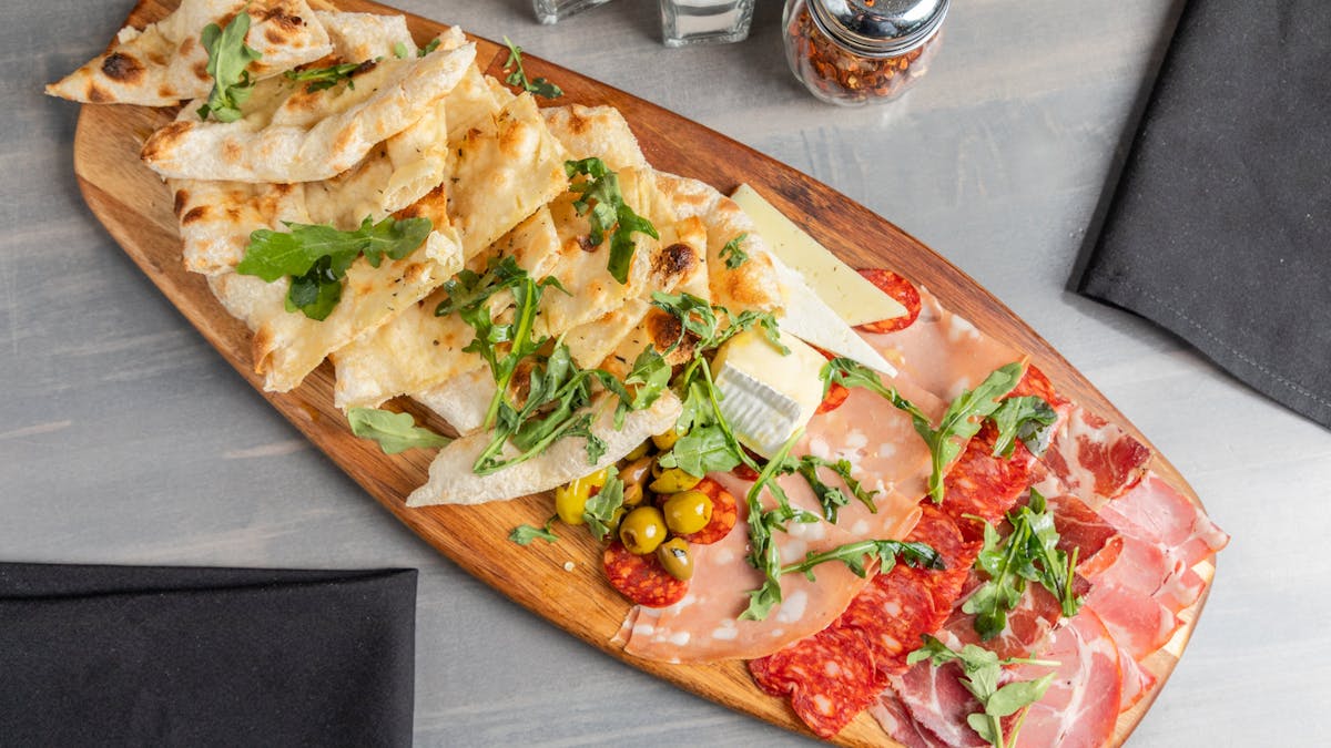 a slice of pizza sitting on top of a wooden table