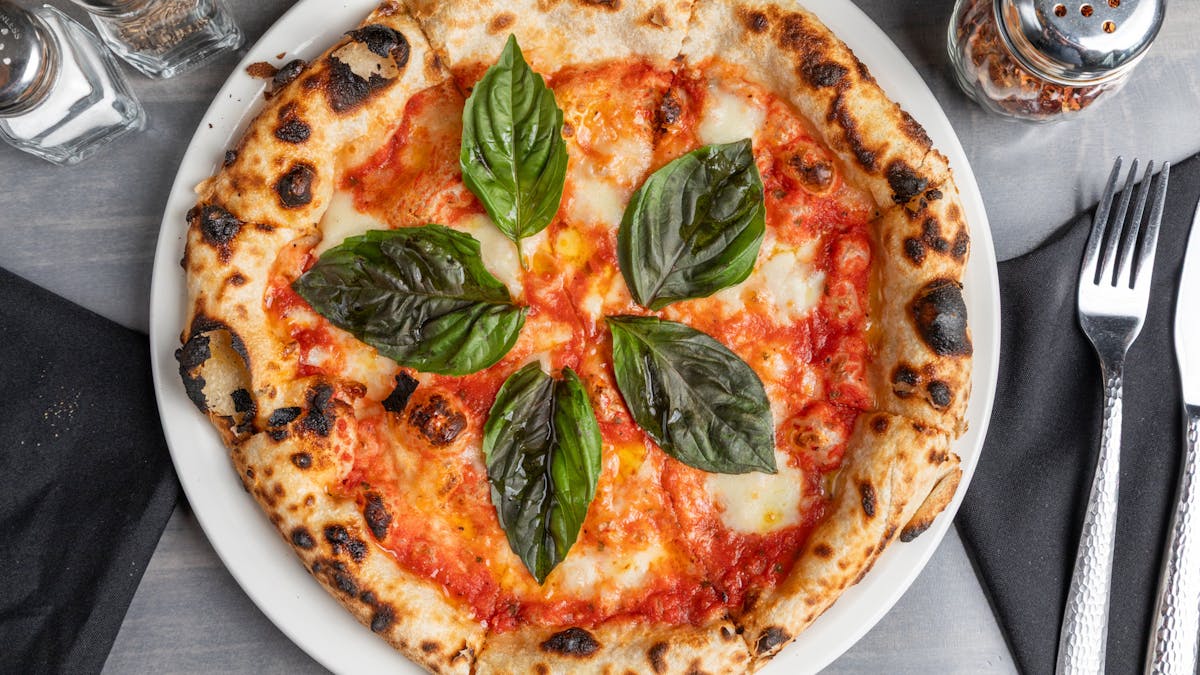a pizza sitting on top of a plate of food