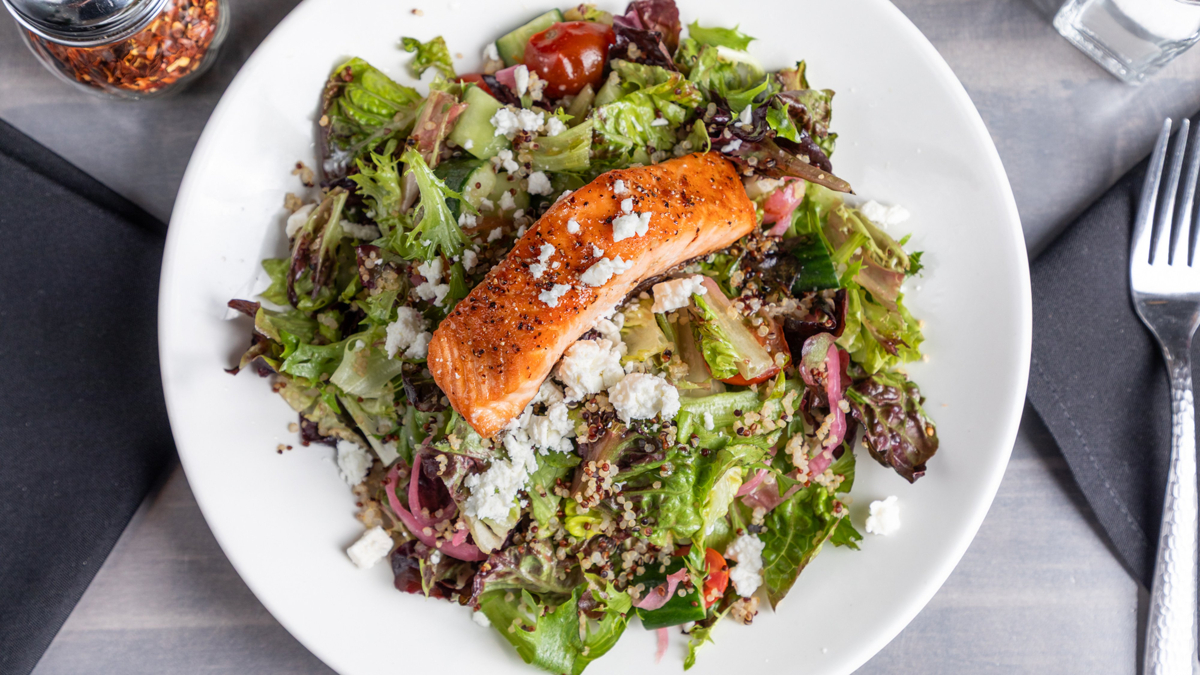 a plate of salad and a fork