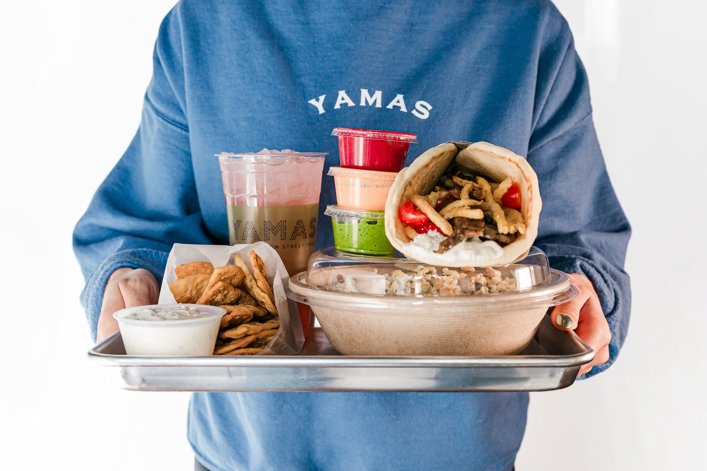 a person sitting in front of a tray of food