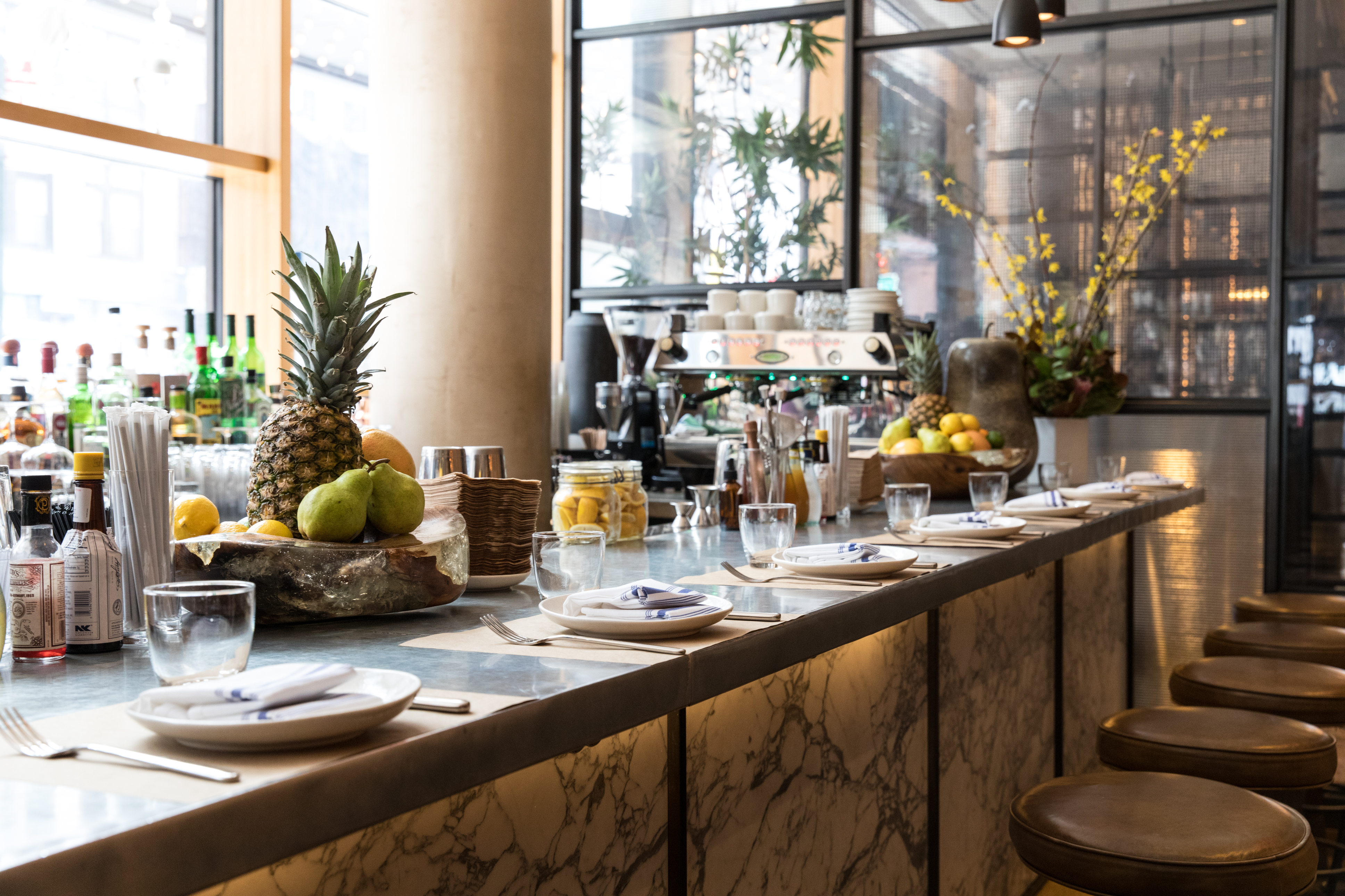 a counter with plates and fruit on it