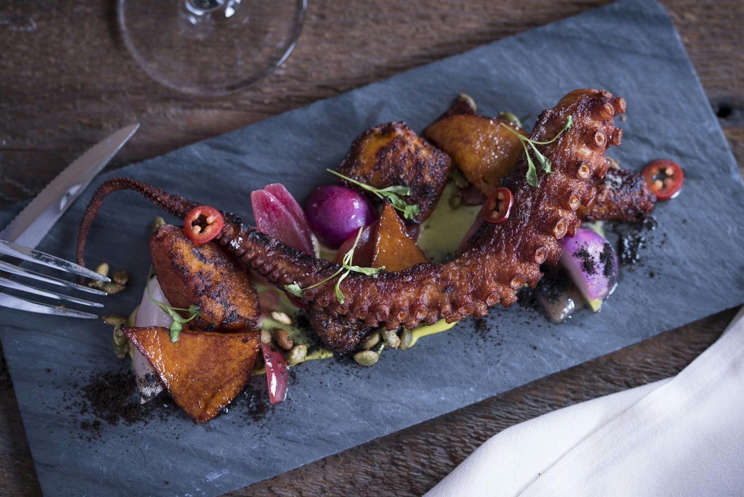 a plate of food sitting on top of a wooden cutting board
