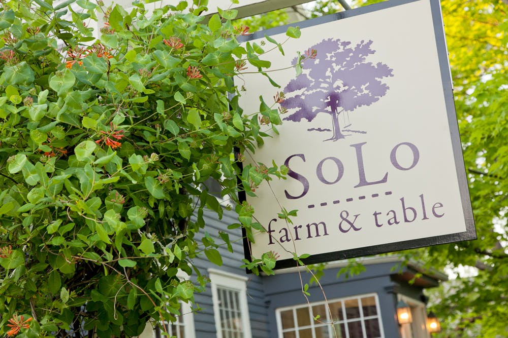 a sign in front of a tree