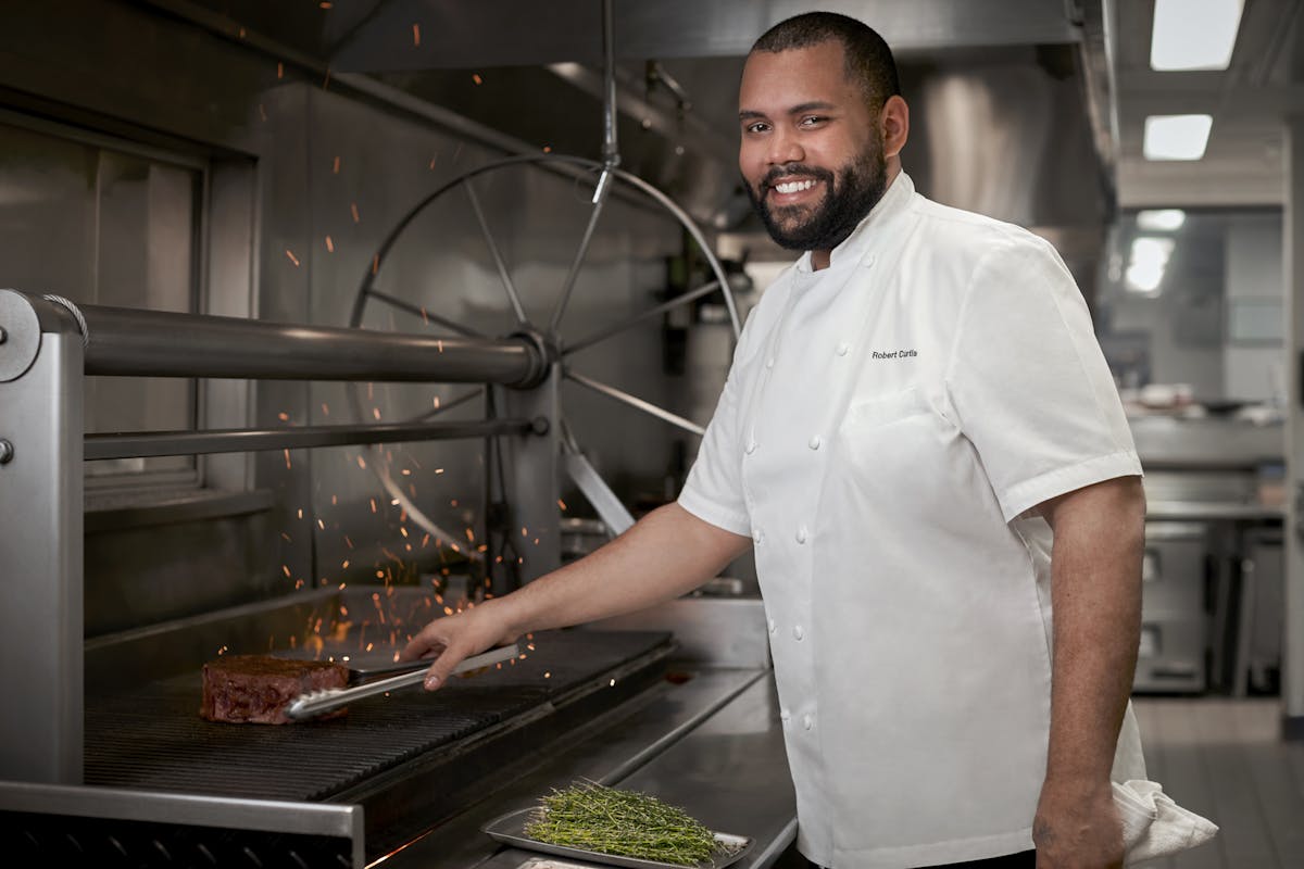 a man cooking in a kitchen preparing food