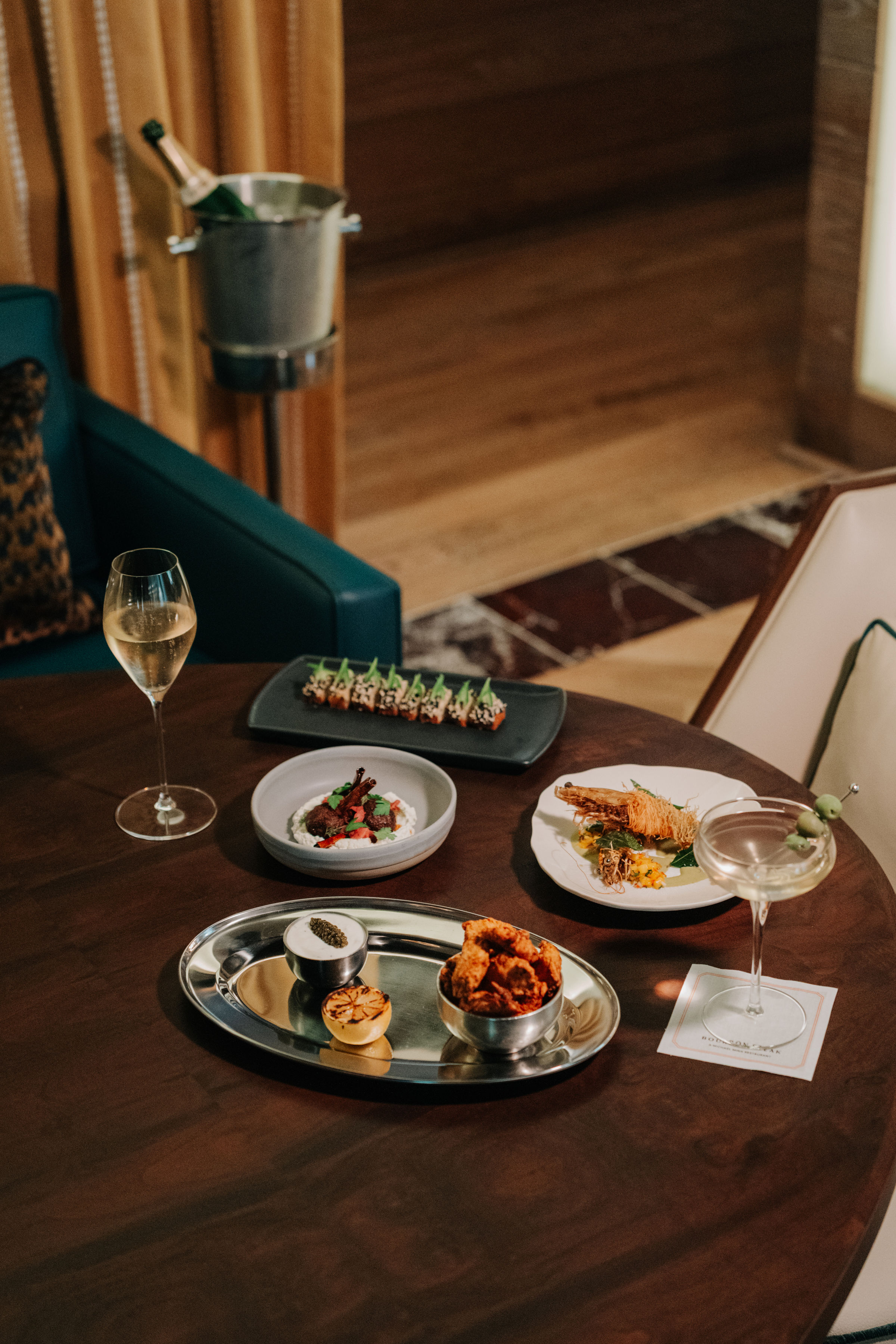 a table with plates of food and a glass of wine