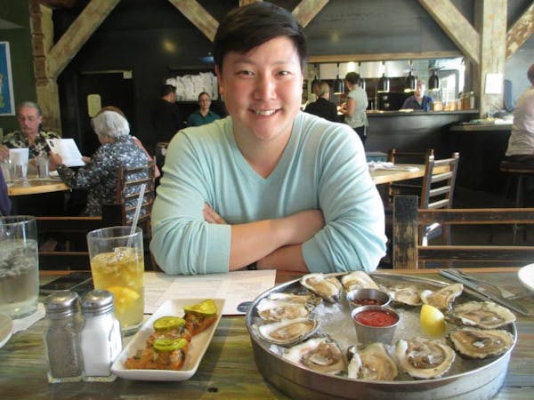 a person sitting at a table with a plate of food