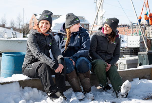 a couple of people that are sitting in the snow