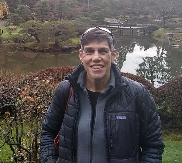 a man standing next to a river