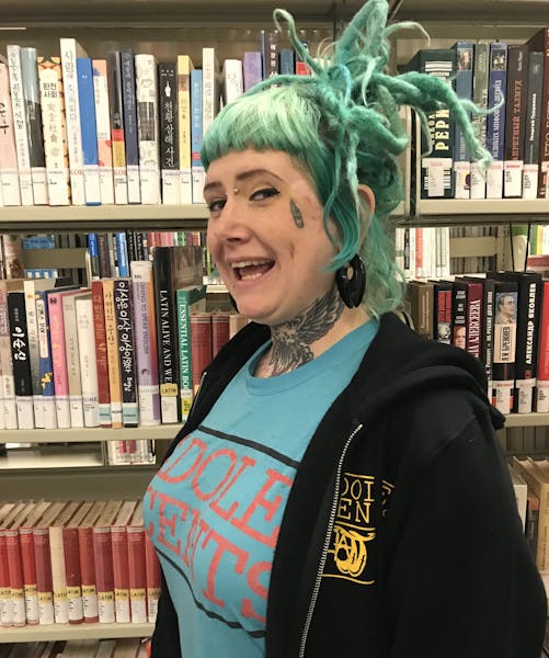 a person standing in front of a book shelf