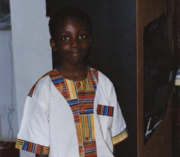 a young boy wearing a white shirt