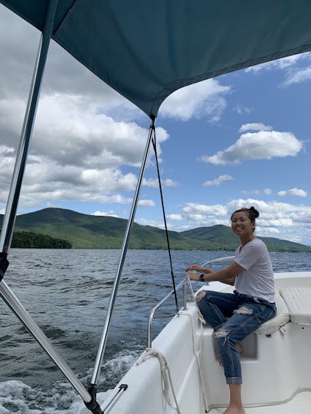 a person riding on the back of a boat in a body of water