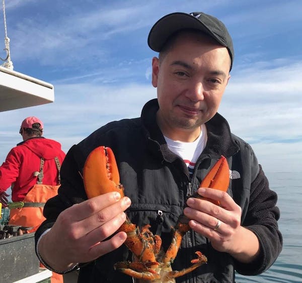 a man holding a lobster
