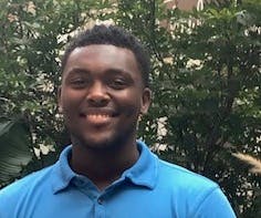 a smiling man in a blue shirt