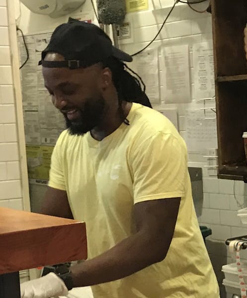 a man cooking in a kitchen preparing food