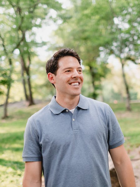 photo of alex standing outside in blue shirt