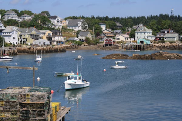 lobster boats in harbor coastal homes