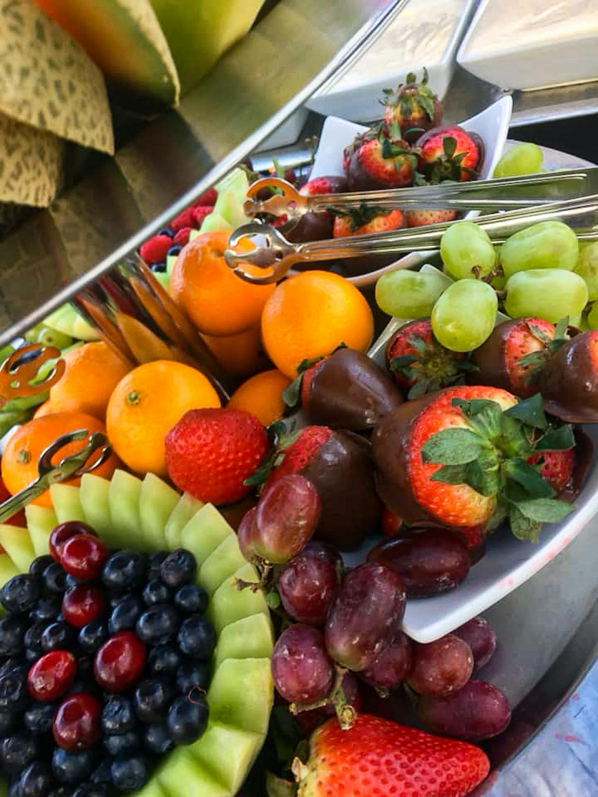a plate is filled with fresh fruit and vegetables